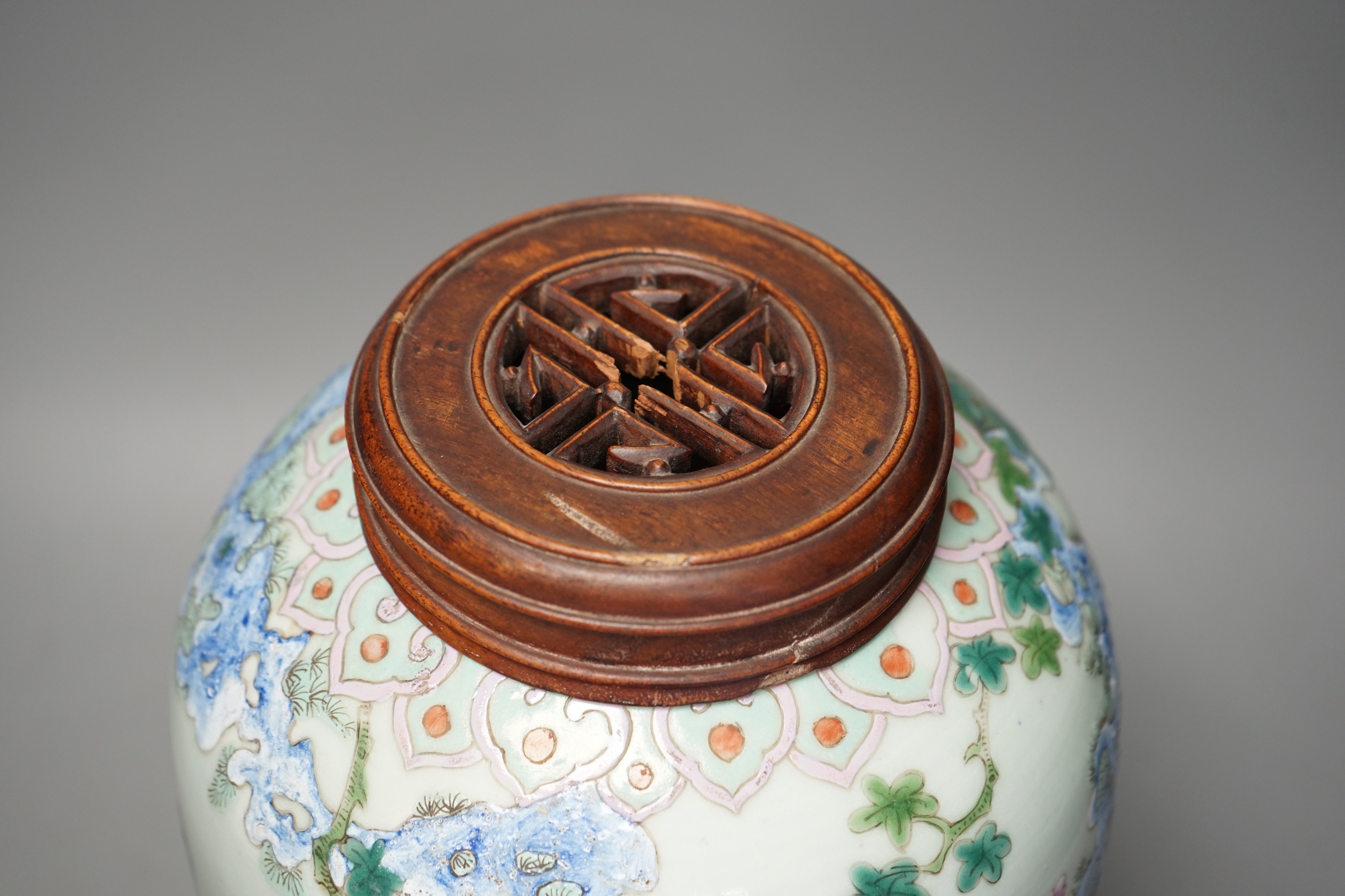 A 19th century Chinese famille rose 'phoenix' jar with wood cover, 30cm tall